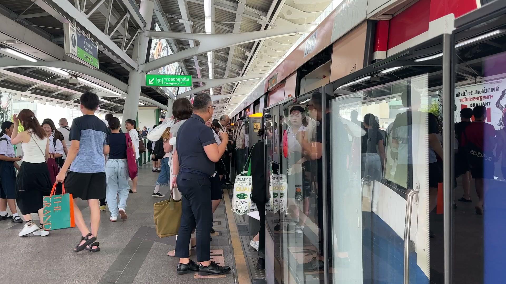 BTS Phrom Phong station exit with directional signage and the surrounding street environment.